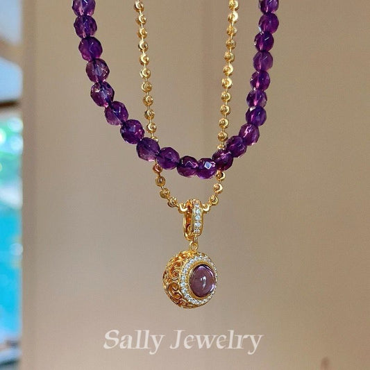 A close-up of the Amethyst Magic Ball Necklace, showcasing its polished purple amethyst sphere as the centerpiece on a sleek and elegant chain.