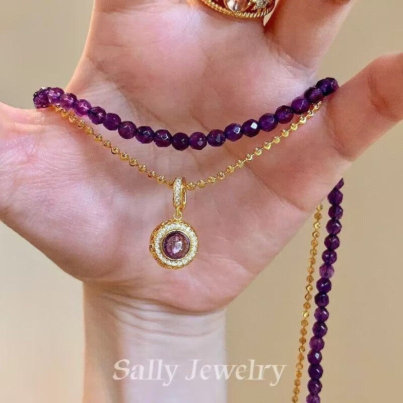 The Amethyst Magic Ball Necklace, featuring a radiant purple amethyst sphere suspended on a sleek chain, exuding elegance and mystique.